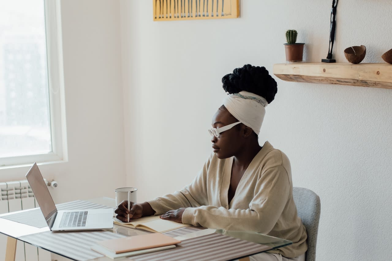 teen girl sitting at a desk writing in a journal